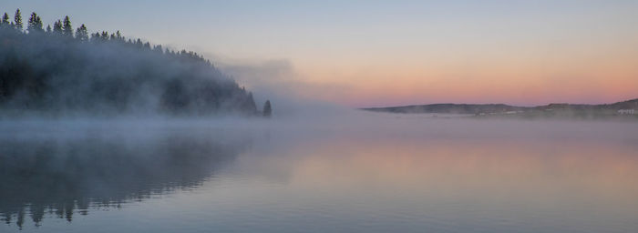 Scenic view of lake against sky during sunset