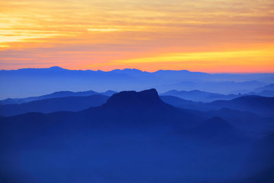 Scenic view of silhouette mountains against sky during sunset