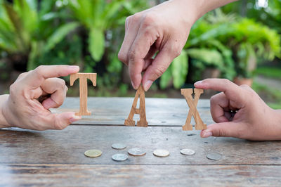 Cropped image of people playing with ball on table