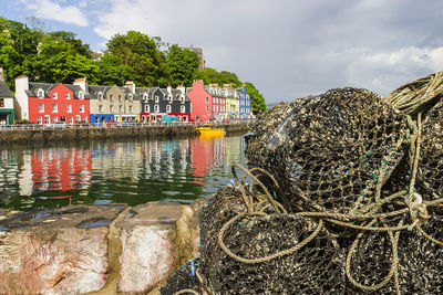 Lobster trap in the harbor of tobermory in scotland with colorful houses