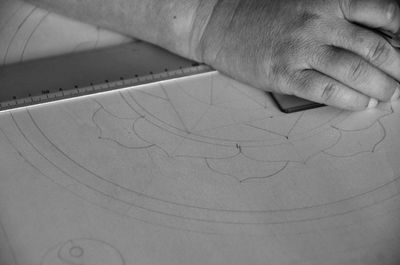 Close-up of architects hand drawing on paper