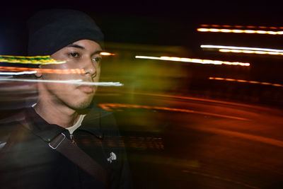 Close-up of young man at night