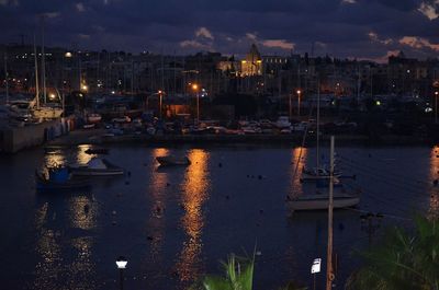 Sailboats in harbor at night