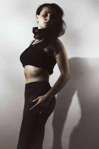 Young woman standing against white background