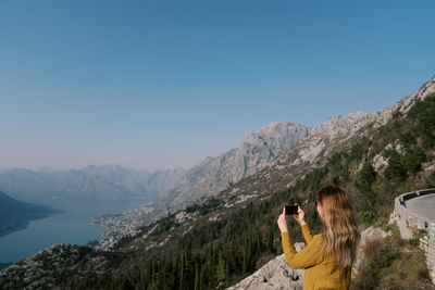 Scenic view of mountains against clear blue sky