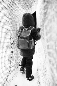 Rear view of child walking jungle gym