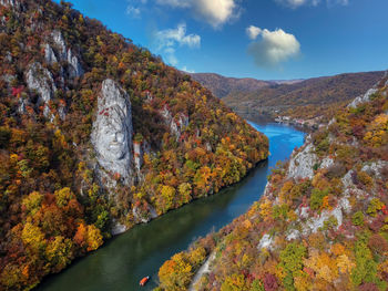 High angle view of river amidst trees against sky