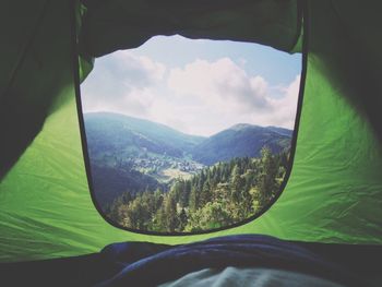 Idyllic view of mountains against sky seen through tent