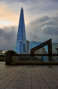 View of modern building against cloudy sky