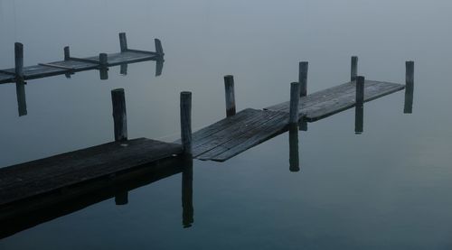 Close-up of pier on sea against sky