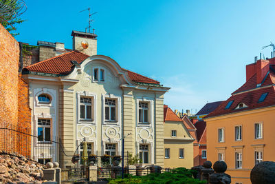 Buildings in town against clear blue sky