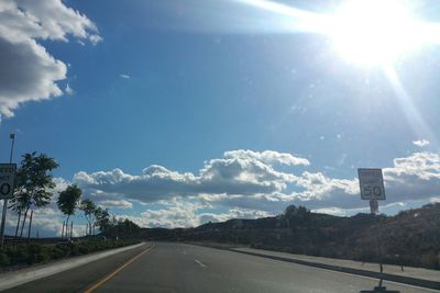 Empty road with trees in background