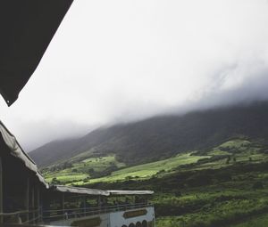 Scenic view of mountains against cloudy sky