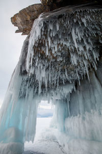 Close-up of icicles on sea shore during winter