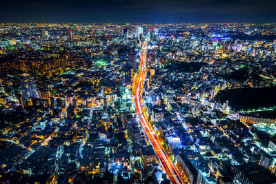 High angle view of illuminated city buildings at night