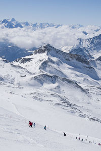 High angle view of people skiing on snowcapped mountain