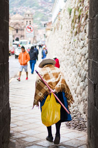Rear view of women walking on street