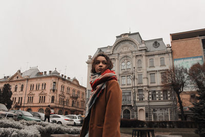 Woman standing in front of building in winter