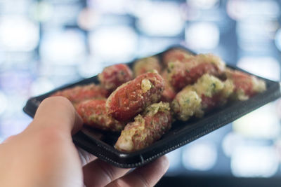 Close-up of hand holding meat