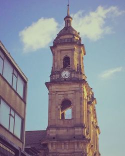 Low angle view of bell tower against sky