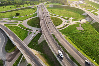 Cars moving on transport road junction in city, aerial view