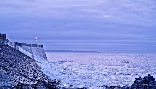 Scenic view of sea against sky with lighthouse in foreground 