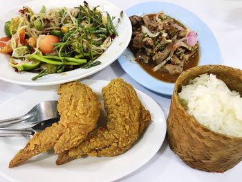 High angle view of meal served in plates on table