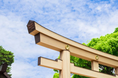 Low angle view of cross on building against sky