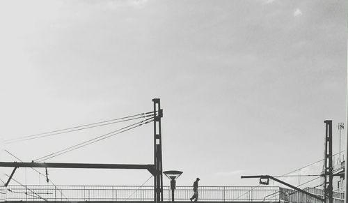 Low angle view of electricity pylon against sky