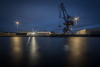 Illuminated commercial dock against sky at night