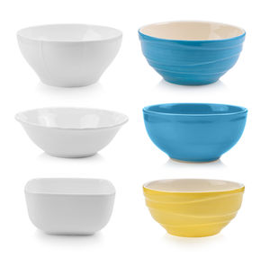 Close-up of ceramic kitchen bowls against white background