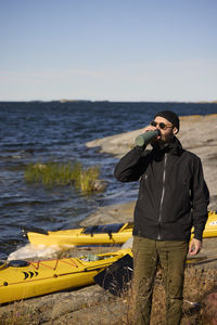 Man relaxing and having drink at sea