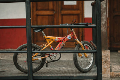 Close-up of bicycle parked against brick wall