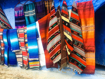 Stack of multi colored moroccan carpets fir sell, chefchaouen, morocco 