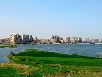 Scenic view of sea and buildings against sky