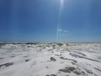 Scenic view of sea against clear blue sky