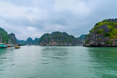 Scenic view of sea and mountains against sky