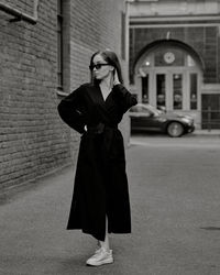 Portrait of young woman walking on street