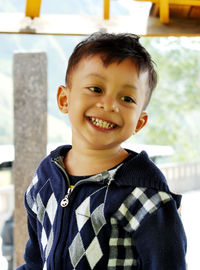 Smiling boy standing indoors