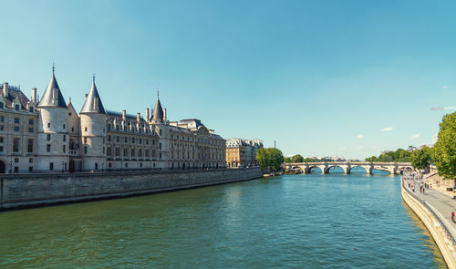 Bridge over river against buildings in city