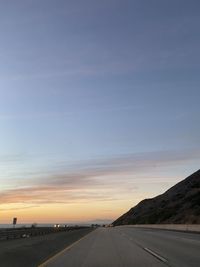 Road against sky during sunset