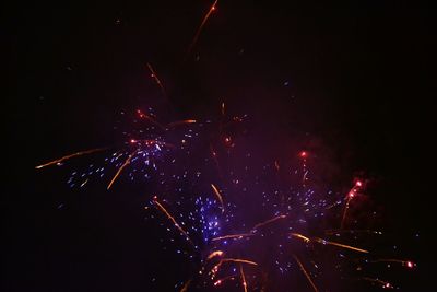 Illuminated firework display at night