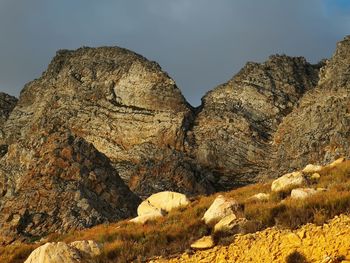 Low angle view of rock formations against sky