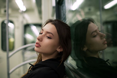 Young woman looking away while traveling in train