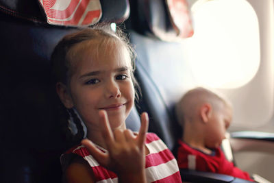 Smiling girl gesturing in plane