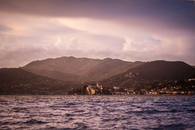 Scenic view of sea and mountains against sky