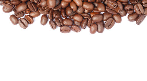 High angle view of coffee beans against white background