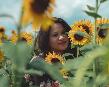 Portrait of smiling woman with sunflower