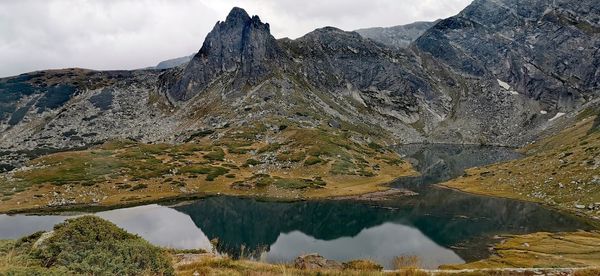 Scenic view of lake and mountains against sky