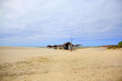 Built structure on beach against sky